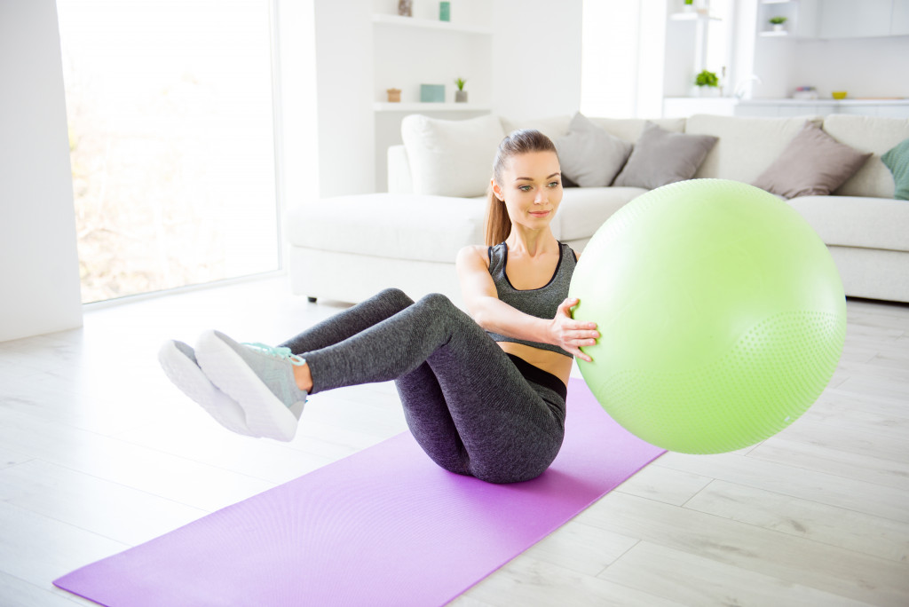 woman exercising using gym ball