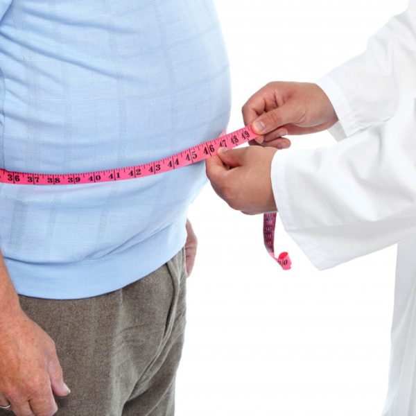 Obese old man being measured