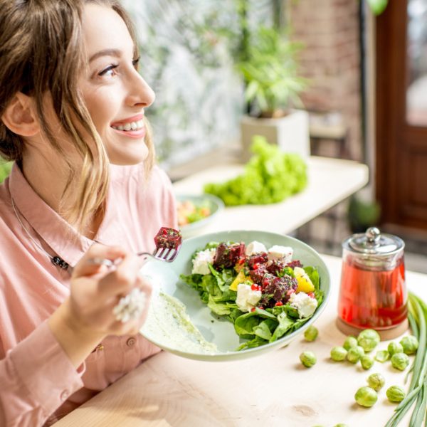 Woman eating a vegetable salad in a restaurant